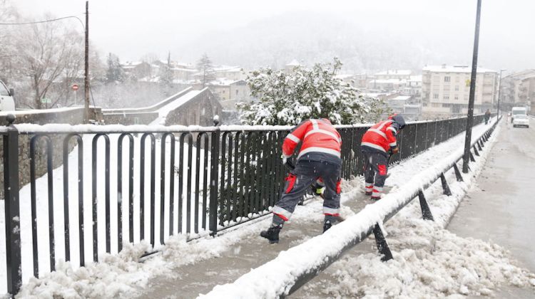 Pla general de dos treballadors retirant la neu del voral del Ter a Sant Joan de les Abadesses