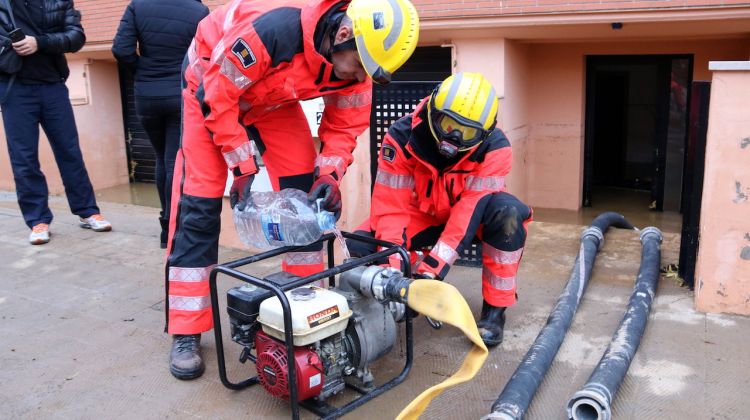 Efectius dels Bombers instal·lant una bomba per retirar aigua dels habitatges inundats de Vilatenim. ACN