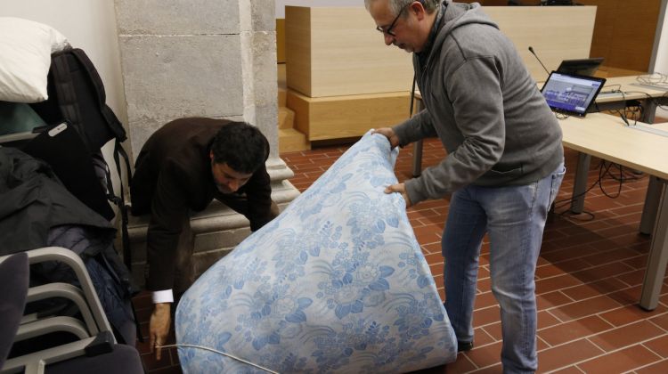 Dos dels professors estirant els matalassos on dormiran la primera nit del dejuni col·lectiu. ACN