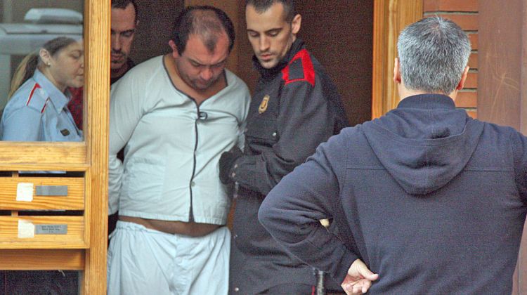 El detingut sortint del pis custodiat pels Mossos d'Esquadra © ACN