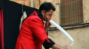 Un artista inflant un globus en un dels espectacles d'avui