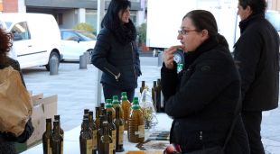 Una dona provant l'Oli de l'Empordà sucat amb pa aquest matí a Girona