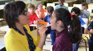 Una professional examina la boca a una alumna de la regió sanitària de Girona