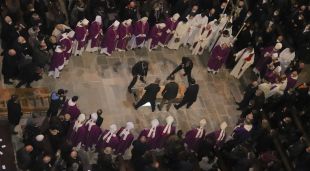 Els treballadors de la funerària baixen el cos del bisbe de Girona, Francesc Pardo, a la tomba que hi ha al mig de la catedral davant de la quinzena d'autoritats eclesiàstiques