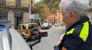 Un agent de la Policia Local de Ripoll mirant la nova aplicació en un control