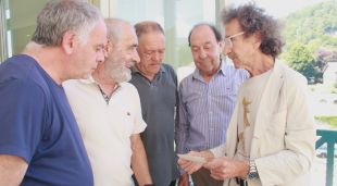 Membres de l'associació comenten una fotografia en paper