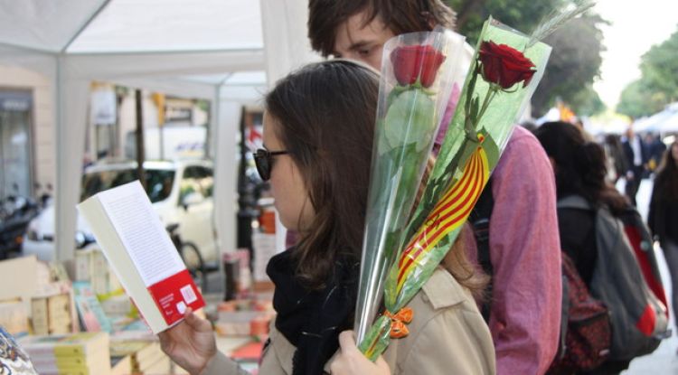 Una parella amb la rosa i el llibre a la Rambla de Girona. ACN