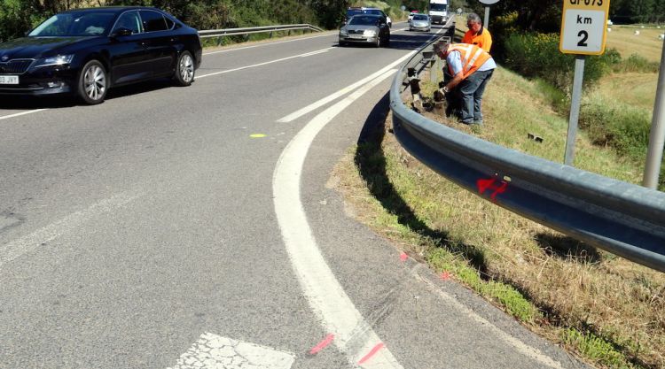 Dos operaris netegen les restes just al punt on ha tingut lloc l'accident. ACN