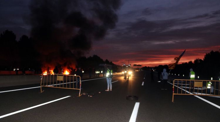 El foc a l'eix, a Manresa, amb els cotxes aturats al fons. ACN