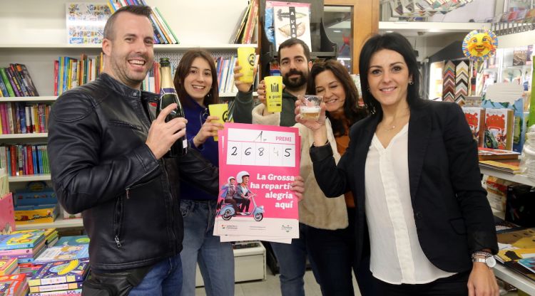 Els propietaris, treballadors de l'estanc de Salt i la representant de Loteria de Catalunya brindant. ACN