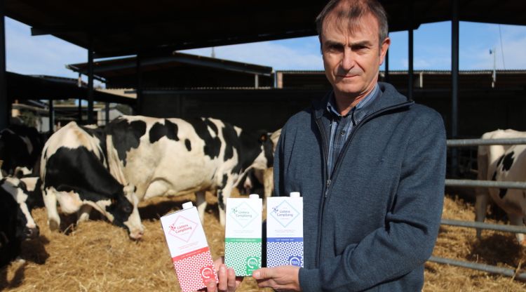 El president de la cooperativa Lletera de Campllong, Joan Pijoan, mostrant els diferents envasos de la marca de llet Lletera Campllong. ACN