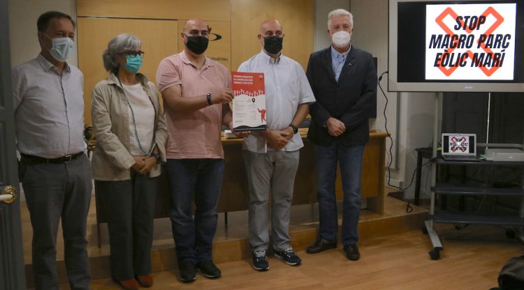 Membres de la plataforma contrària al parc eòlic marí projectat al golf de Roses amb el cartell de l'acte de dissabte. ACN
