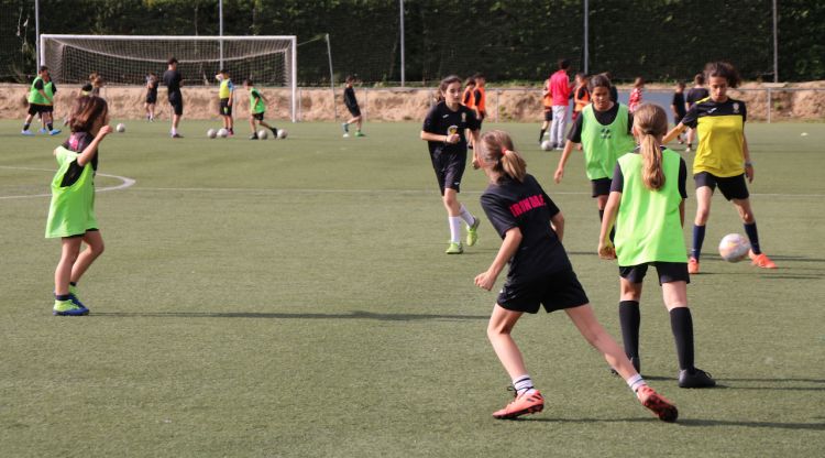 Les jugadores del Gerunda FC compartint el camp de Fontajau amb l'equip masculí Atlètic Sant Ponç al fons. ACN