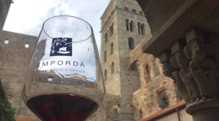 El monestir de Sant Pere de Rodes amb una copa de vi de la DO Empordà