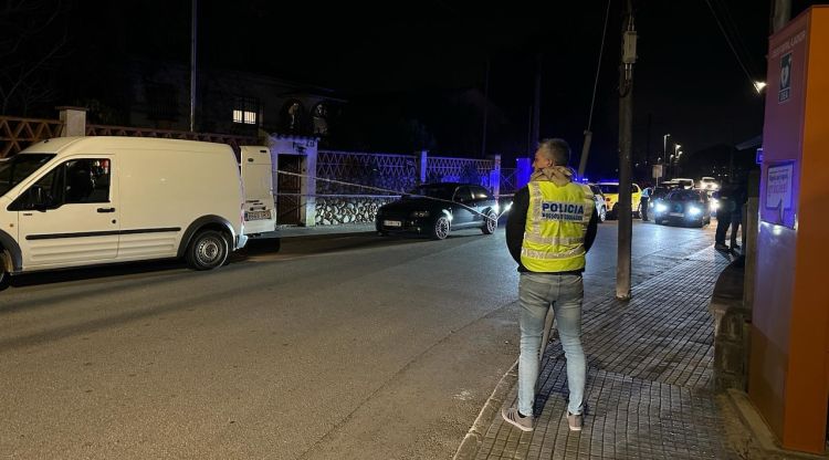 Un mosso d'esquadra davant de la porta de la finca on ha tingut lloc el tiroteig. ACN