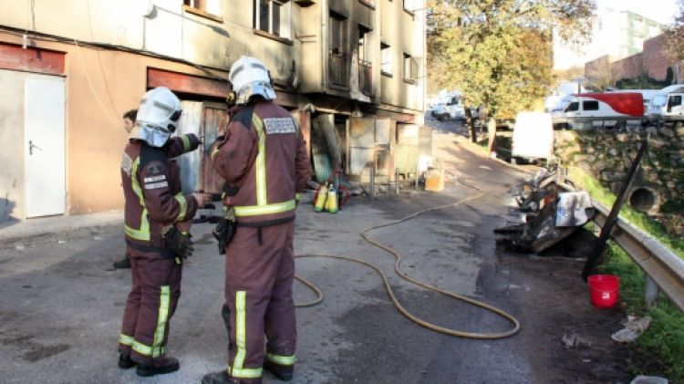 Bombers treballant en el foc en els baixos d'un edifici del barri gironí de la Font de la Pólvora al desembre passat