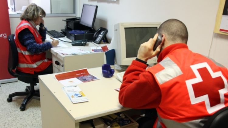 Voluntaris de la Creu Roja fent trucades a gent gran de les comarques gironines © ACN