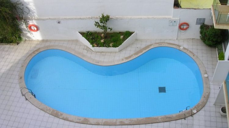 La piscina, de petites dimensions, es troba envoltada de balcons