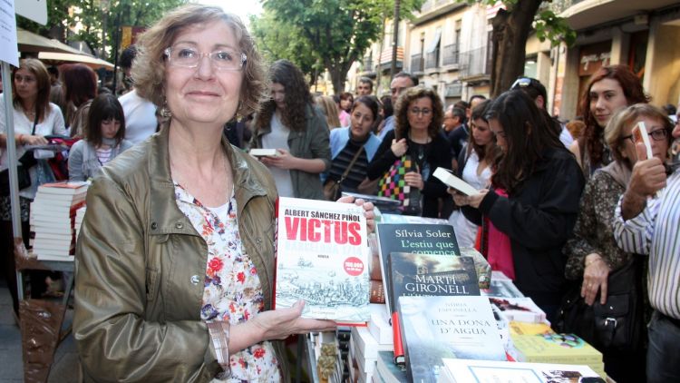 La presidenta del Gremi de Llibreters de Girona, Carme Ferrer, amb els títols més venuts d'aquest Sant Jordi © ACN