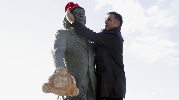 L'alcalde de Cadaqués, Joan Figueras, posant una barretina a l'estàtua de Salvador Dalí © ACN