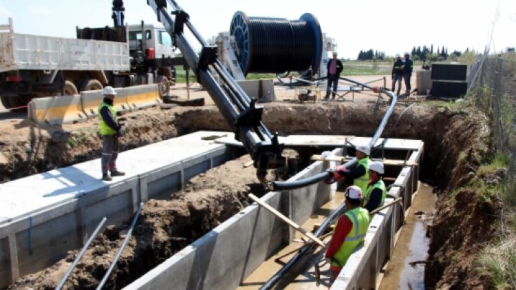 Els operaris estenent el cable subterrani de la MAT © ACN